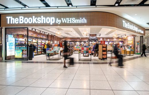 Image of the exterior of The Bookshop by Whsmith with people walking past in a blur.