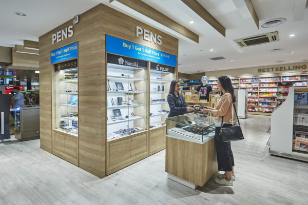 Interior of WHSmith airport store with colleague serving customer